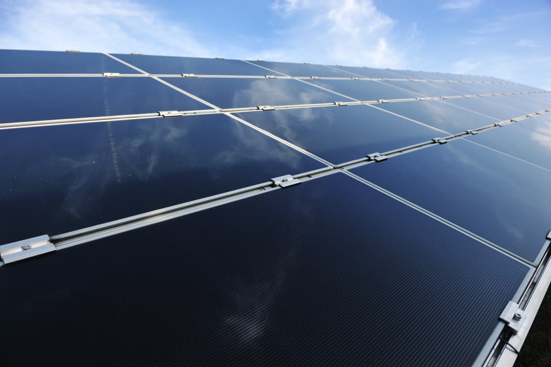 alternative-energy-photovoltaic-solar-panels-against-blue-sky-SBI-300931275.jpg